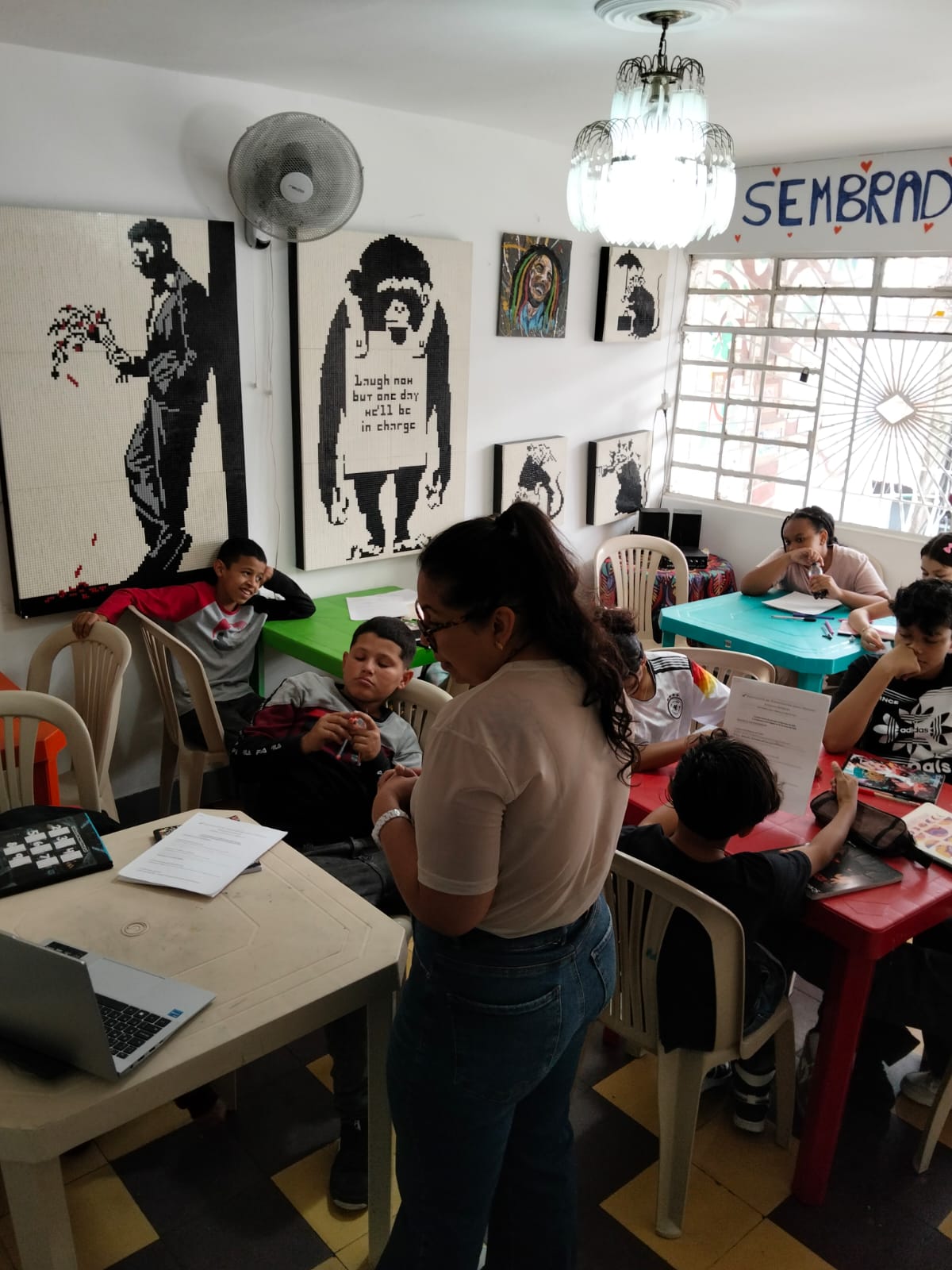 Students working on their business plans surrounded by mosaic street art