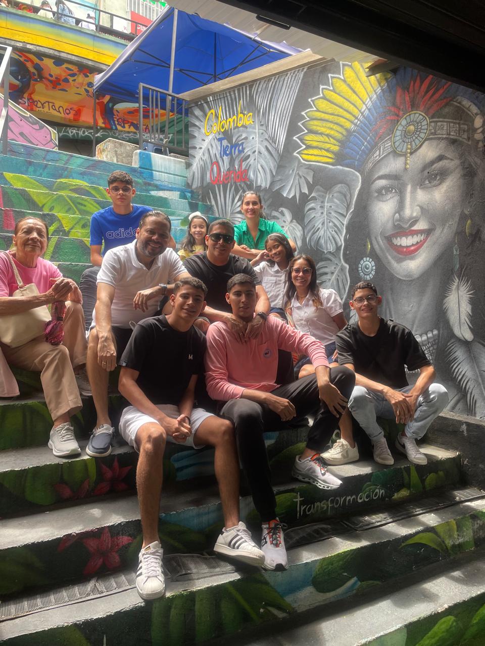Family group sitting on the painted stairs of Comuna 13