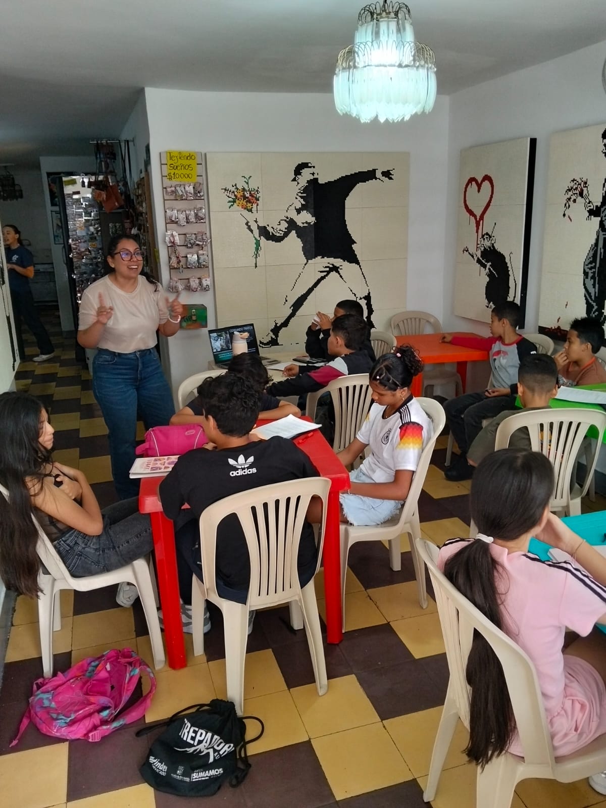 Teacher leading a business class for teens at Sembradores de Amor