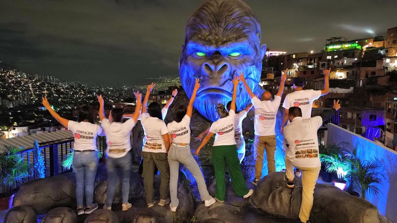 Funsatours guides at the King Kong sculpture lit up at night