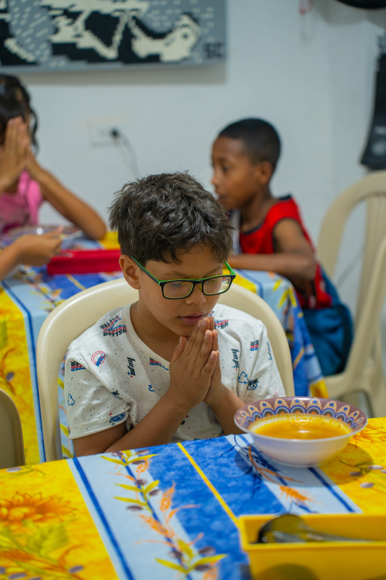 Children sharing a meal in the community dining hall