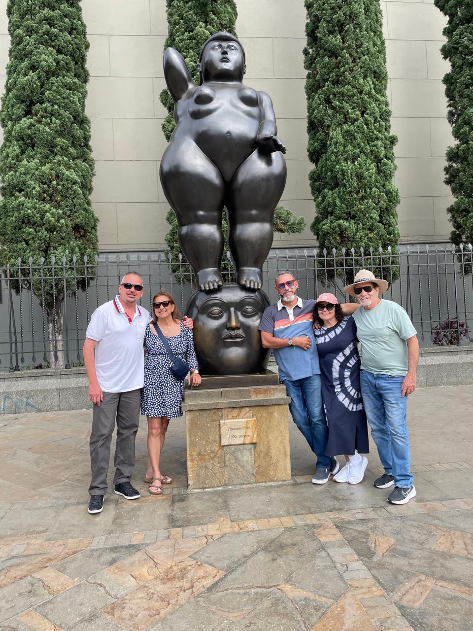 Travellers beside a Botero sculpture on the Medellín Highlights tour